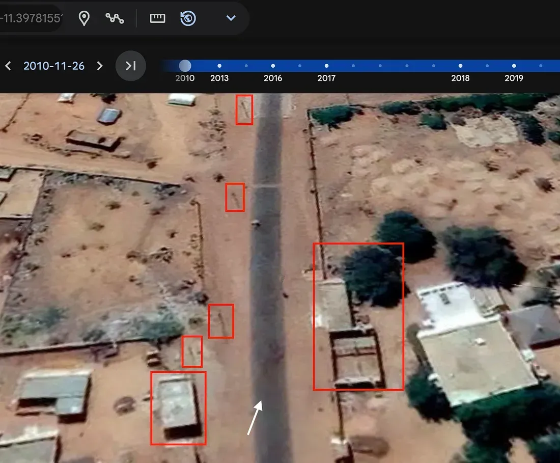 Historical satellite image with buildings, trees, and people highlighted